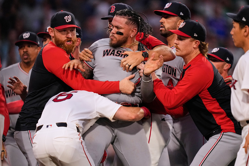 Washington Nationals' Andrés Chaparro, center, is held back as tempers flare during the fourth inning of a baseball game against the Boston Red Sox, Tuesday, June 30, 2026, in Boston. (AP Photo/Charles Krupa)