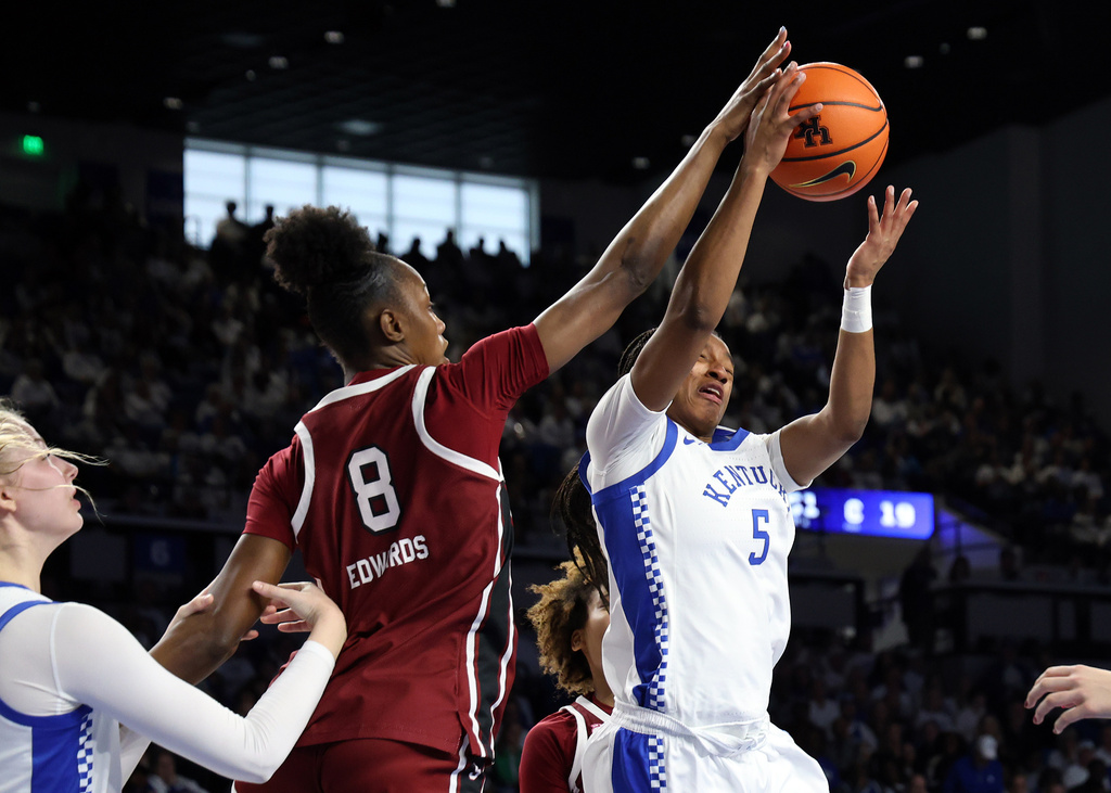 Kentucky's Tonie Morgan (5) has her shot blocked by South Carolina's Joyce Edwards (8) during an NCAA college basketball game in Lexington, Ky., Sunday, March 1, 2026. (AP Photo/James Crisp)