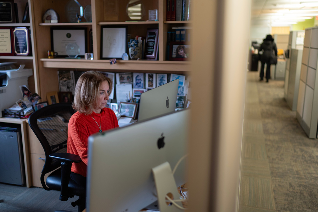 CORRECTS TITLE OF KAPLAN - Dr. Mariana Kaplan, head of systemic autoimmunity research at the National Institute of Arthritis and Musculoskeletal and Skin Diseases at the National Institutes of Health, works in her office, Tuesday, Jan. 21, 2025, in Washington. (AP Photo/David Goldman)