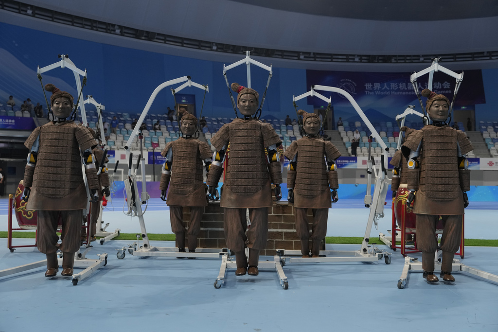 Robots dressed like terracotta warriors are setup before the opening ceremony of The World Humanoid Robot Games held in Beijing, China, Thursday, Aug. 14, 2025. (AP Photo/Ng Han Guan)