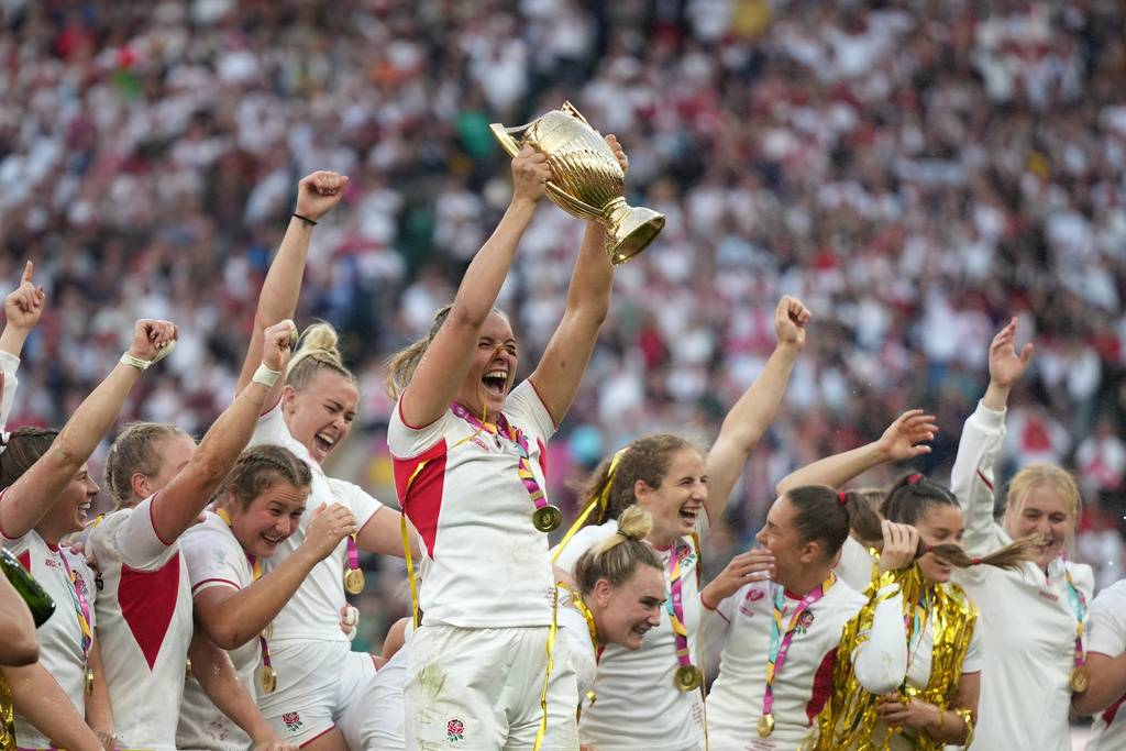 England's Zoe Aldcroft holds a trophy as she celebrates with her teammates after winning the Women's Rugby World Cup final match between England and Canada at the Allianz Stadium, Twickenham, London, Saturday, Sept. 27, 2025. (AP Photo/Alastair Grant)