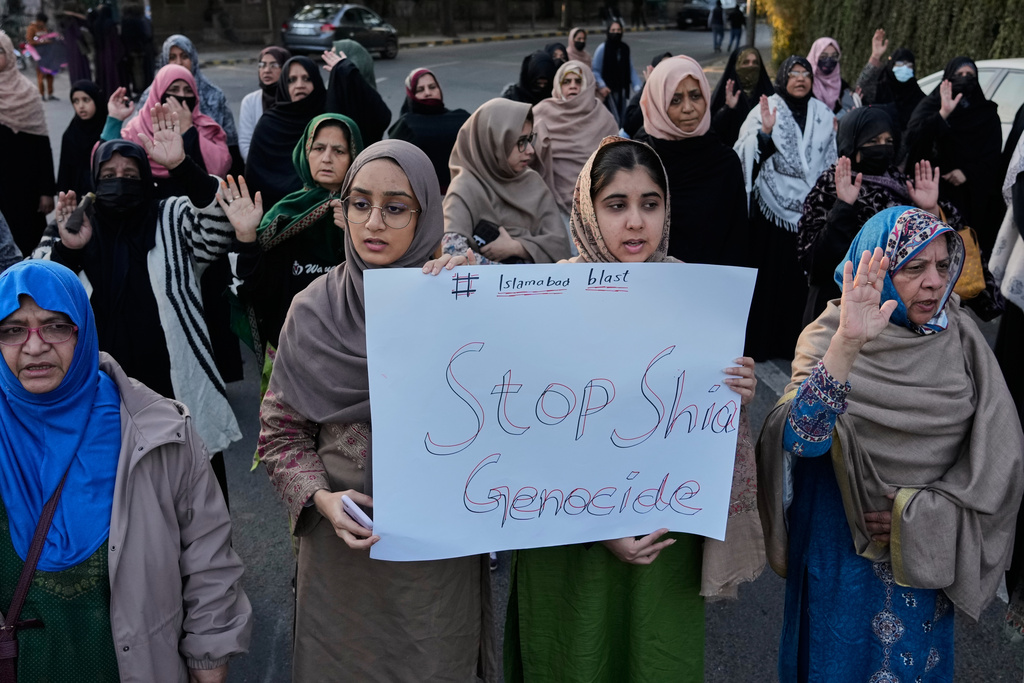 Shiite muslims hold a placard during a protest in Lahore, Pakistan, Saturday, Feb. 7, 2026, against Friday's suicide bombing inside a Shiite mosque in Islamabad. (AP Photo/K.M. Chaudary)