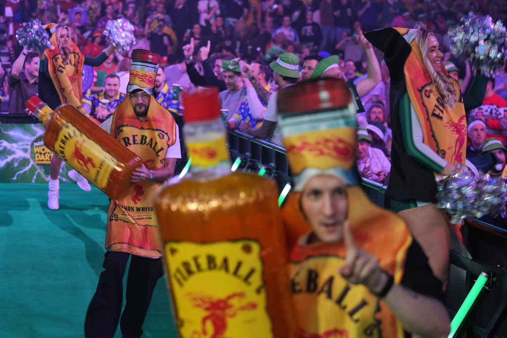 Dancers perform during a Round 1 match at the World Darts Championships at Alexandra Palace in London, Friday, Dec. 12, 2025. (AP Photo/Kin Cheung)