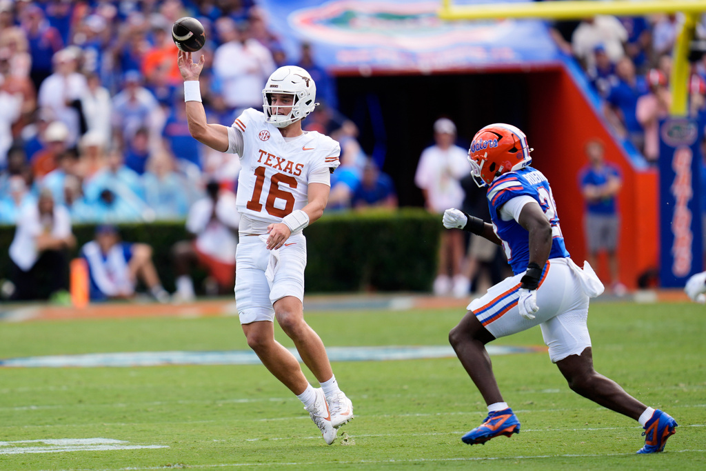 Texas quarterback Arch Manning (16) throws a pass as Florida linebacker Jaden Robinson, right, rushes during the first half of an NCAA college football game, Saturday, Oct. 4, 2025, in Gainesville, Fla. (AP Photo/John Raoux)