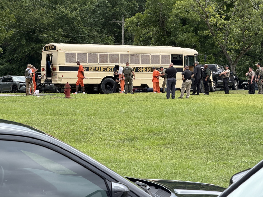In this photo provided by the North Carolina State Bureau of Investigation, law enforcement officers loads inmates for transport Monday, June 29, 2026, at the Bertie-Martin Regional Detention Center in Windsor, N.C. (North Carolina Bureau State Bureau of Investigation via AP)