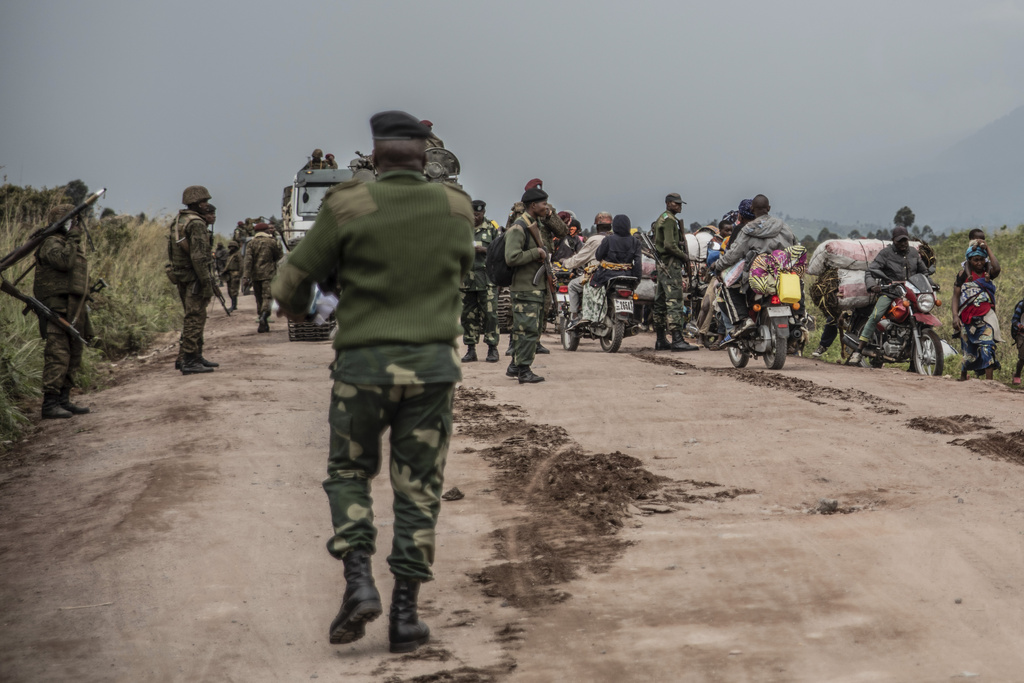 FILE - People walk on the road near Kibumba, north of Goma, Democratic Republic of Congo, as they flee fighting between Congolese forces and M23 rebels in North Kivu, May 24, 2022. (AP Photo/Moses Sawasawa, file)