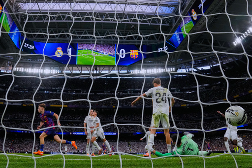 Barcelona's Fermin Lopez, left, celebrates after scoring his side's first goal past Real Madrid's goalkeeper Thibaut Courtois, bottom right, during the Spanish La Liga soccer match between Real Madrid and Barcelona, in Madrid, Sunday, Oct. 26, 2025. (AP Photo/Manu Fernandez) Barcelona's Fermin Lopez, left, celebrates after scoring his side's first goal past Real Madrid's goalkeeper Thibaut Courtois, bottom right, during the Spanish La Liga soccer match between Real Madrid and Barcelona, in Madrid, Sunday, Oct. 26, 2025. (AP Photo/Manu Fernandez)