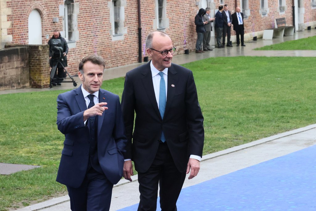French President Emmanuel Macron, left, and Germany's Chancellor Friedrich Merz arrive for the EU summit at Alden Biesen Castle in Bilzen-Hoeselt, Belgium, Thursday, Feb. 12, 2026. (AP Photo/Francois Walschaerts)