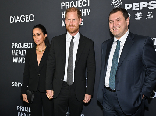 Meghan Markle, left, and Prince Harry, The Duke and Duchess of Sussex, center, pose with Project Healthy Minds founder and CEO Phillip Schermer at the third annual World Mental Health Day Gala, hosted by Project Healthy Minds, at Spring Studios on Thursday, Oct. 9, 2025, in New York. (Photo by Evan Agostini/Invision/AP) Meghan Markle, left, and Prince Harry, The Duke and Duchess of Sussex, center, pose with Project Healthy Minds founder and CEO Phillip Schermer at the third annual World Mental Health Day Gala, hosted by Project Healthy Minds, at Spring Studios on Thursday, Oct. 9, 2025, in New York. (Photo by Evan Agostini/Invision/AP)