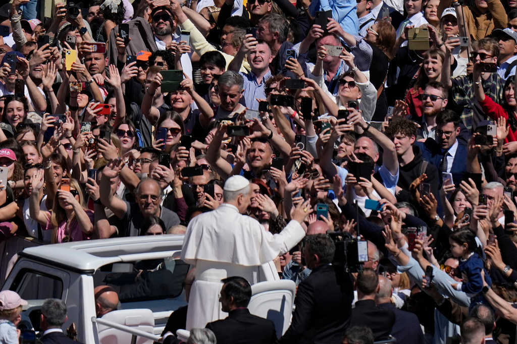 Pope Leo XIV greets the faithful at the end of Easter Mass he presided over in St. Peter's Square at the Vatican, Sunday, April 5, 2026. (AP Photo/Alessandra Tarantino)