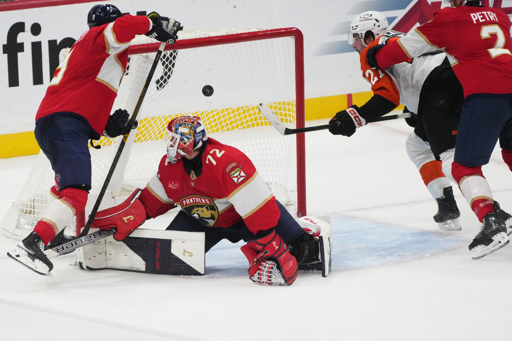 Philadelphia Flyers left wing Noah Cates (27), right, scores a goal against Florida Panthers goaltender Sergei Bobrovsky (72) during the second period of an NHL hockey game, Thursday, Oct. 9, 2025, in Sunrise, Fla. (AP Photo/Marta Lavandier)