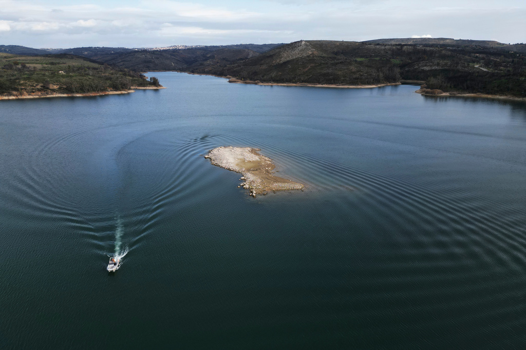 An islet that recently emerged is seen at Lake Marathon near Athens, Greece, on Tuesday, Jan. 6, 2026, as receding water levels reflect years of low rainfall. (AP Photo/Thanassis Stavrakis)