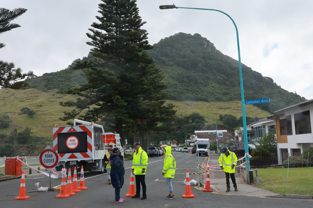 Emergency workers attend the scene after a landslide hit a campground at Mt. Maunganui, New Zealand, Thursday, Jan. 22, 2026. (Mark Taylor/Waikato Times/Stuff via AP)