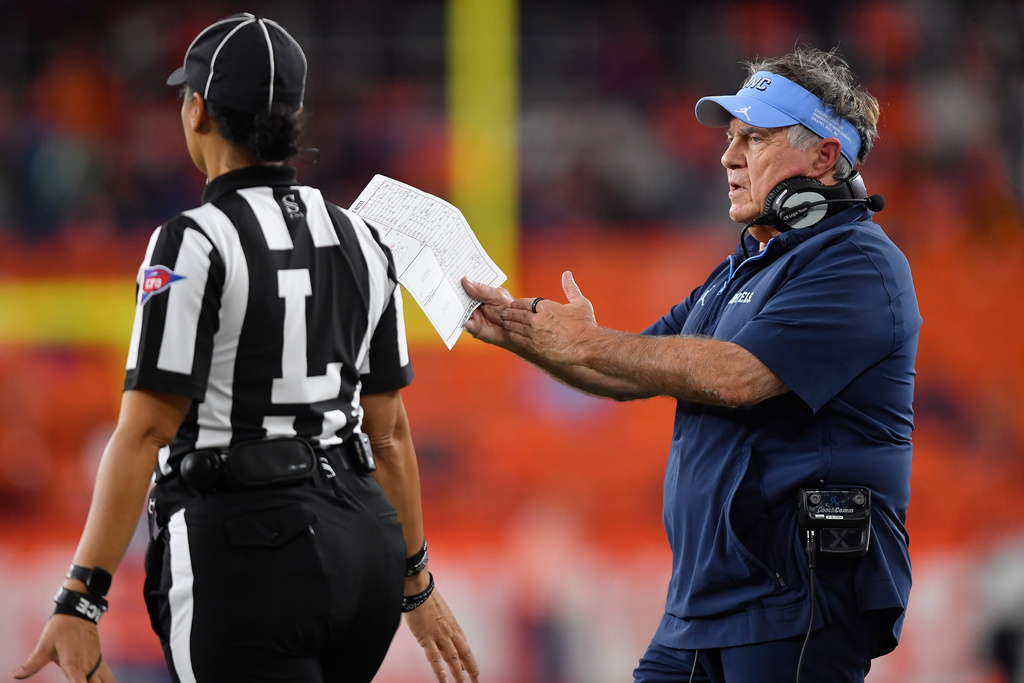 North Carolina head coach Bill Belichick, right, calls a timeout during the first half of an NCAA college football game against Syracuse Friday, Oct. 31, 2025, in Syracuse, N.Y. (AP Photo/Adrian Kraus)