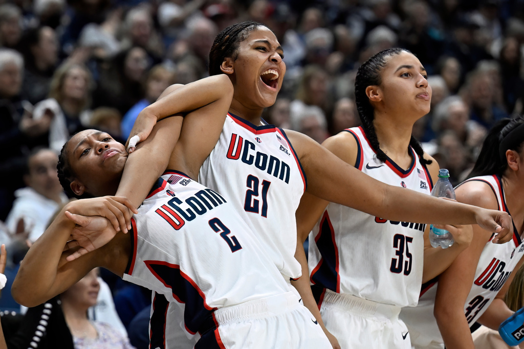 UConn guard KK Arnold (2), UConn forward Sarah Strong (21) and UConn guard Azzi Fudd (35) react from the bench in the second half of an NCAA college basketball game against Villanova, Thursday, Jan. 15, 2026, in Storrs, Conn. (AP Photo/Jessica Hill)