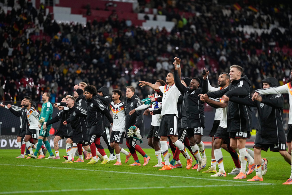 German players celebrate qualifying for the World Cup after beating Slovakia in Leipzig, Germany, Monday, Nov. 17, 2025. (AP Photo/Matthias Schrader)