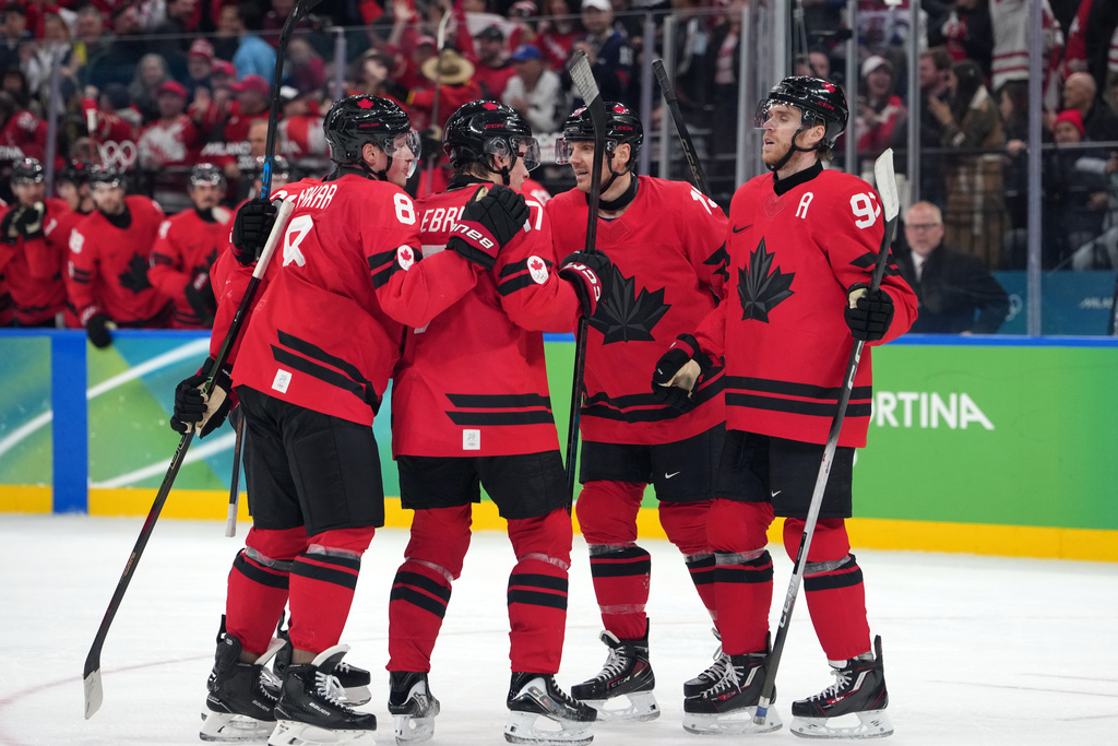 Team Canada players celebrate after a goal by Nathan MacKinnon during the second period of a men's ice hockey quarterfinal game against Czechia at the 2026 Winter Olympics, in Milan, Italy, Wednesday, Feb. 18, 2026. (AP Photo/Carolyn Kaster)