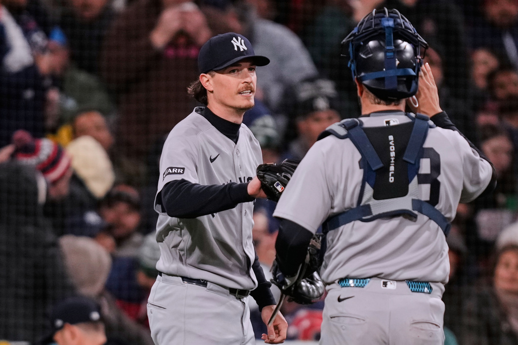 New York Yankees pitcher Max Fried, left, congratulates catcher Austin Wells after completing the sixth inning of a baseball game against the Boston Red Sox at Fenway Park, Wednesday, April 22, 2026, in Boston. (AP Photo/Charles Krupa)