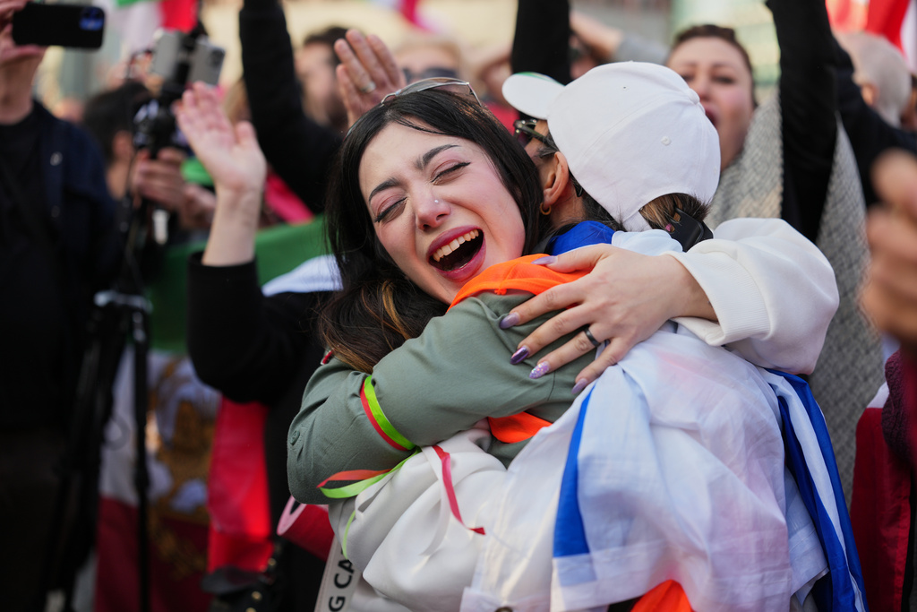 Iranian people attend a demonstration in support of the U.S. and Israeli strikes on Iran, in Berlin, Germany, Saturday, Feb. 28, 2026. (AP Photo/Markus Schreiber)