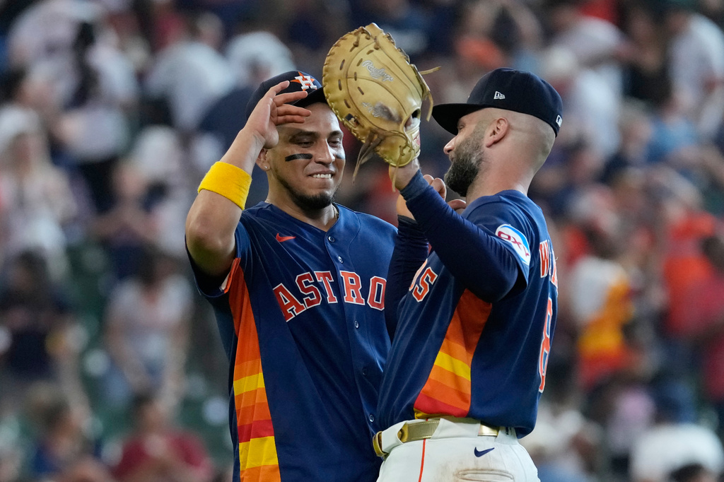 Houston Astros' Isaac Paredes, left, and Christian Walker celebrate after a baseball game against the Tampa Bay Rays Sunday, July 5, 2026, in Houston. (AP Photo/David J. Phillip)