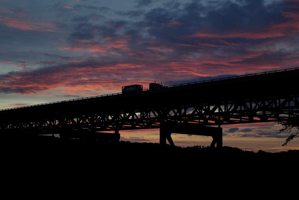 A truck drives over the New River Gorge Bridge at sunset, Sept. 16, 2025, in Victor, W.Va. (AP Photo/Carolyn Kaster)