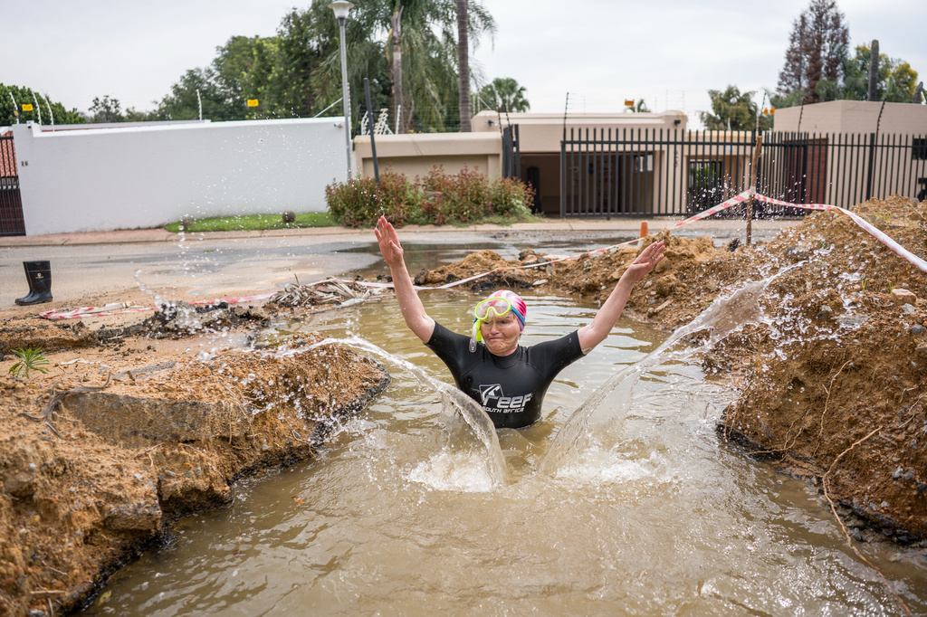Johannesburg mayoral candidate Helen Zille takes a swim in a pool in a road created by a water leak in Johannesburg, South Africa, Saturday, March 28, 2026. (Jacques Nelles/Democratic Alliance via AP)