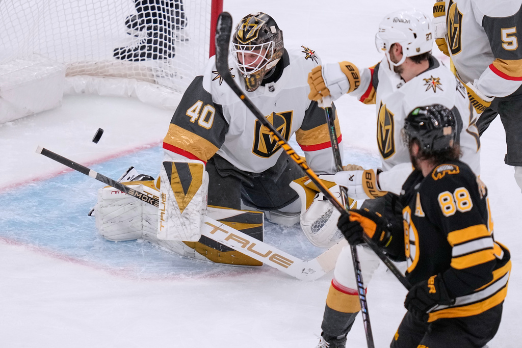 Vegas Golden Knights goaltender Akira Schmid (40) looks at the puck on a goal by Boston Bruins right wing David Pastrnak (88) during the second period of an NHL hockey game, Thursday, Jan. 22, 2026, in Boston. (AP Photo/Charles Krupa)