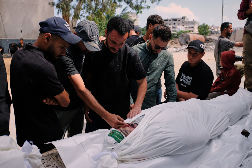 Palestinians mourn over the body of Mohammad Odeh, whom Israel says was a leader of Hamas Qassam Brigades, a day after he was killed in an Israeli airstrike, during his funeral in Gaza City, Wednesday, May 27, 2026. (AP Photo/Jehad Alshrafi)