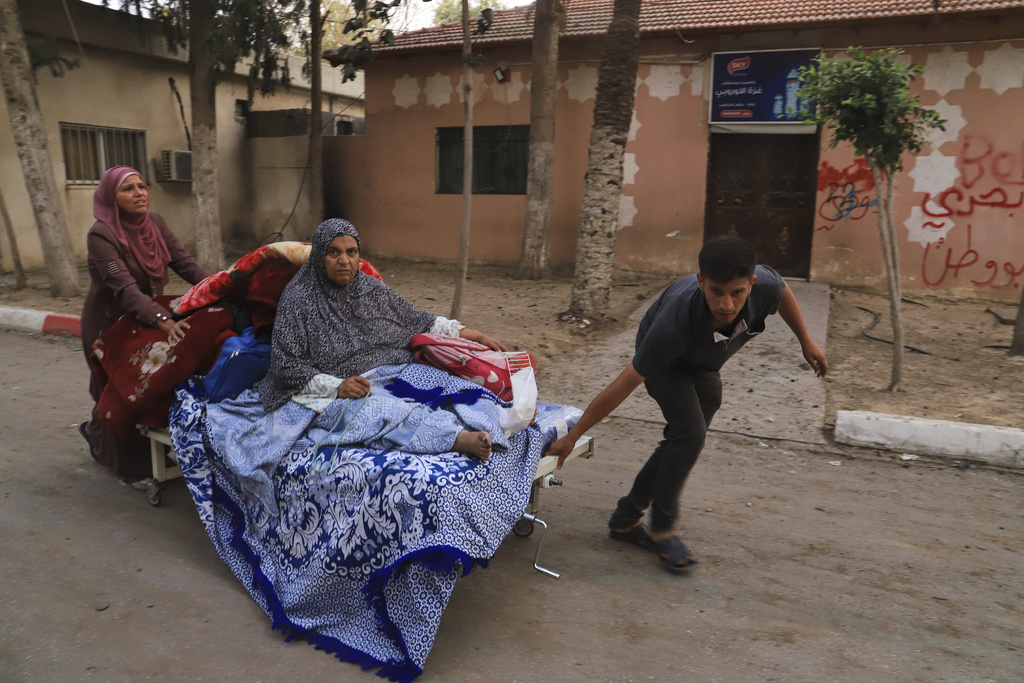 FILE - Palestinians evacuate patients from the European hospital in Khan Younis, Gaza, after it was hit by an Israeli army airstrike, Tuesday, May 13, 2025. The Israeli military said it had carried out a strike targeting what it said was a Hamas "command and control center" located beneath the hospital. (AP Photo/Mariam Dagga, File)