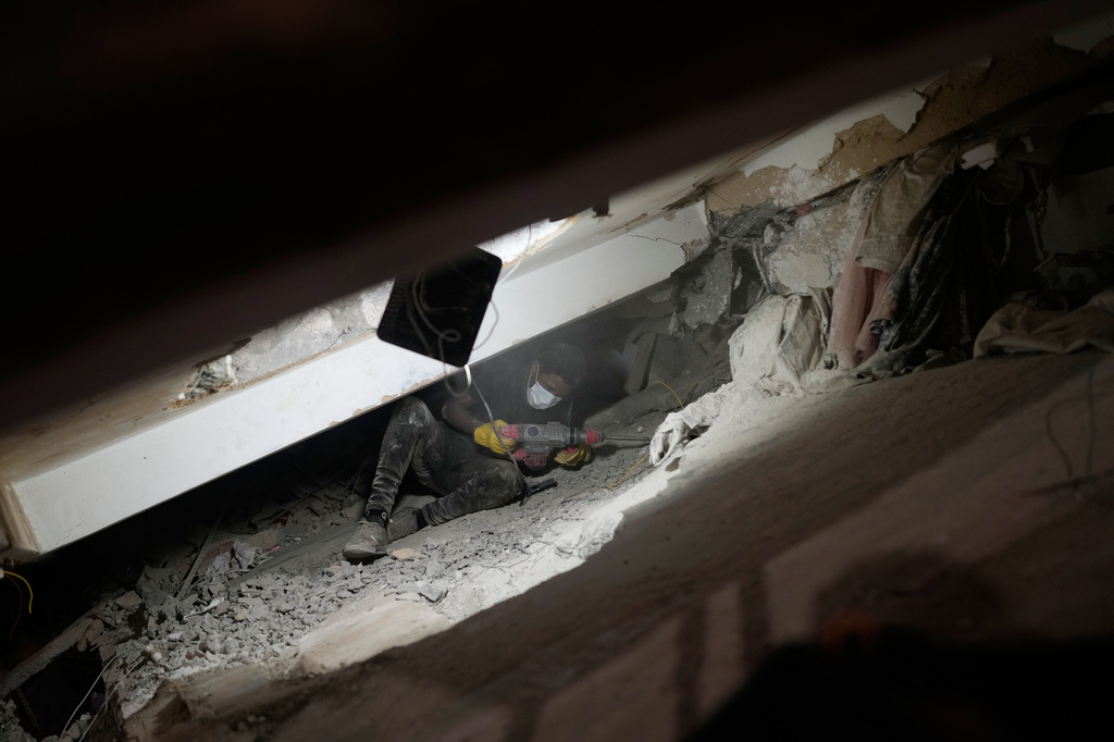 A man searches through the rubble of a building that collapsed in the earthquakes in La Guaira, Venezuela, Tuesday, June 30, 2026. (AP Photo/Ariana Cubillos)