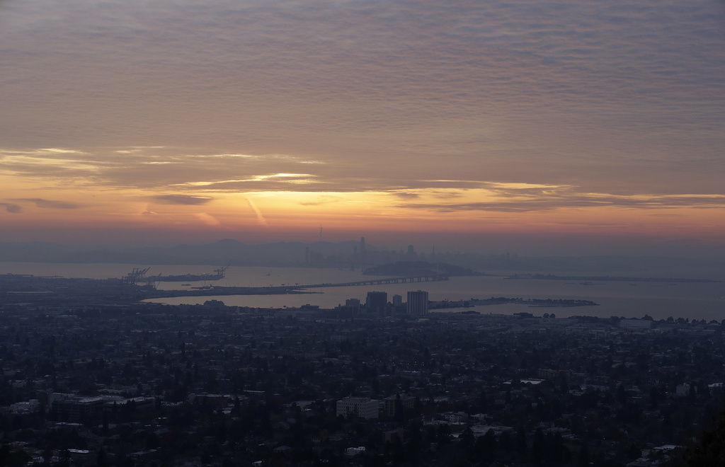 FILE - The San Francisco skyline and the eastern span of the Bay Bridge are shown from Berkeley, Calif., Dec. 22, 2017. (AP Photo/Jeff Chiu, file)