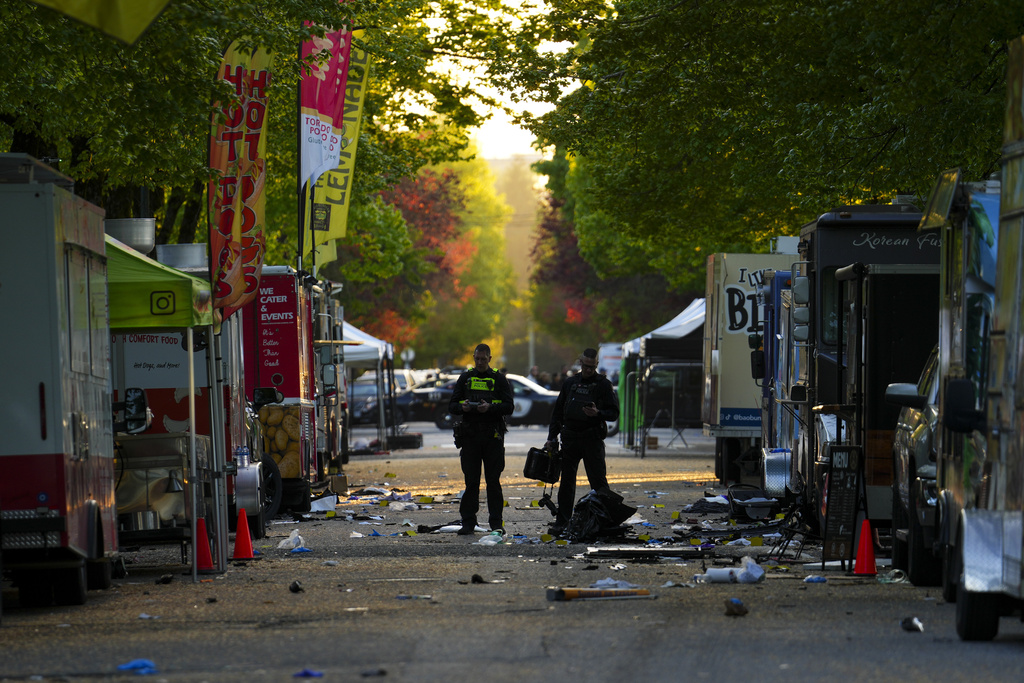 FILE - Members of the Vancouver Police forensics team examines the scene where a vehicle drove into a crowd during a Filipino heritage festival in Vancouver, Canada, April 27, 2025. (Sean Kilpatrick/The Canadian Press via AP, File)