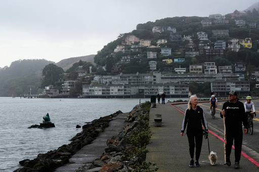 People walk on a sidewalk next to the San Francisco Bay in Sausalito, Calif., Sunday, Oct. 26, 2025. (AP Photo/Godofredo A. Vásquez) People walk on a sidewalk next to the San Francisco Bay in Sausalito, Calif., Sunday, Oct. 26, 2025. (AP Photo/Godofredo A. Vásquez)