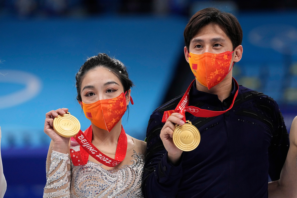 FILE - Gold medalists, Sui Wenjing and Han Cong, of China, pose during a medal ceremony after the pairs free skate program during the figure skating competition at the 2022 Winter Olympics, Feb. 19, 2022, in Beijing. (AP Photo/David J. Phillip, file)