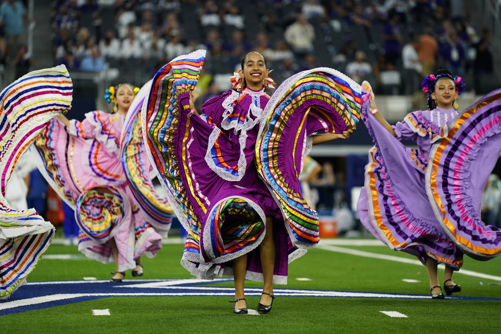 A folklorico dance group performs at haltfime of an NFL football game between the Baltimore Ravens and Dallas Cowboys in Arlington, Texas, Sunday, Sept. 22, 2024. (AP Photo/Jeffrey McWhorter)