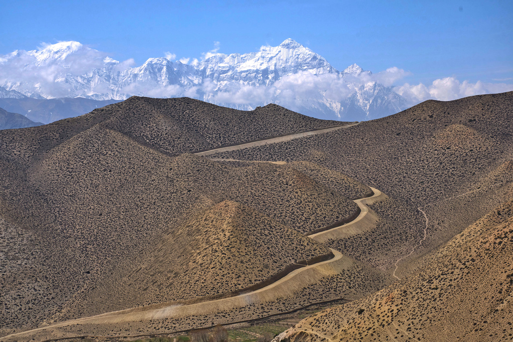 FILE- A dirt road through barren mountains in the Mustang region, 462 kilometers (288 miles) west of Kathmandu, Nepal, Thursday, April 17, 2025. (AP Photo/Niranjan Shrestha, File)