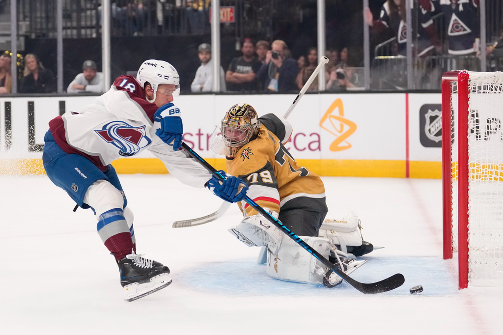 Colorado Avalanche's Jack Drury, left, scores on Vegas Golden Knights goaltender Carter Hart during the first period in Game 3 of the Western Conference finals NHL hockey Stanley Cup playoff series, Sunday, May 24, 2026, in Las Vegas. (AP Photo/Mark J. Terrill) CORRECTION: Name corrected to Jack Drury not Cale Makar.
