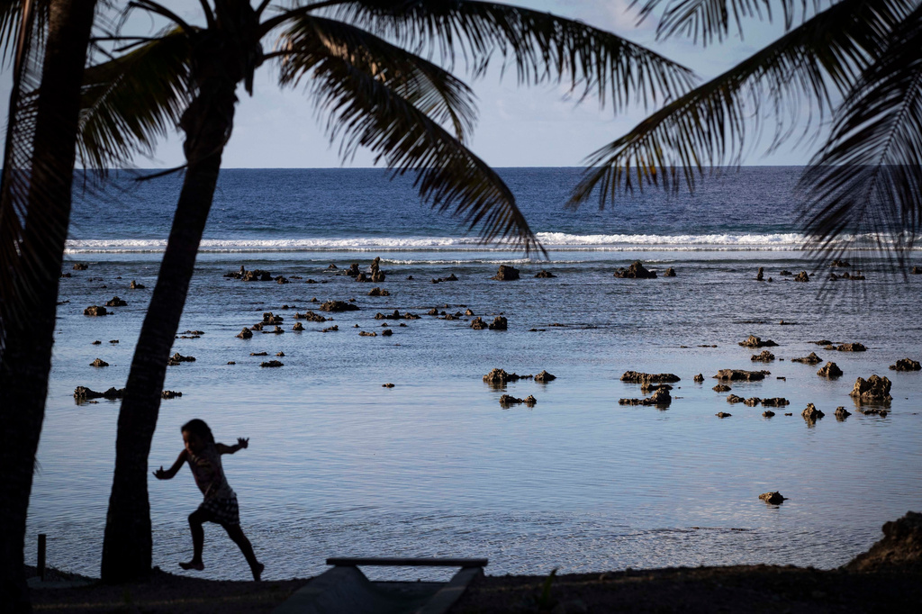 FILE- A child plays near the beach in Nauru during the Pacific Islands Forum on the tiny Pacific nation of Nauru Monday, Sept. 3, 2018. (Jason Oxenham/Pool Photo via AP, File)