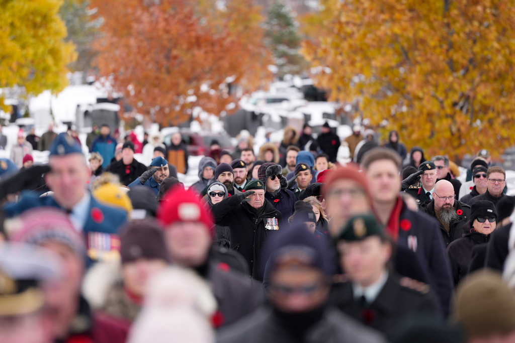 Veterans and Canadian Forces members salute during the playing of the Last Post at a Remembrance Day ceremony at the national military Cemetery at Beachwood in Ottawa on Tuesday, Nov. 11, 2025. (Justin Tang /The Canadian Press via AP)
