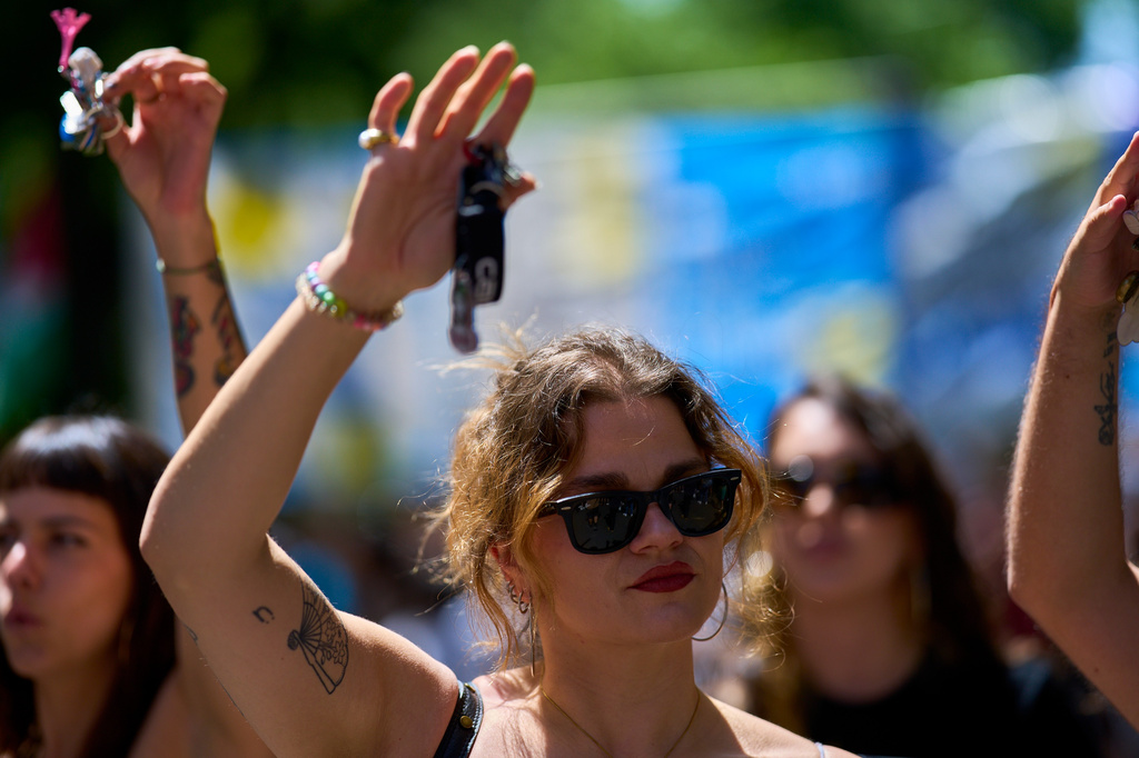 A woman holds up a set of keys as a symbol of protest during a protest in Madrid, Spain, Sunday, May 24, 2026, against rising housing costs that are pricing many Spaniards out of the market amid Spain's broader housing crisis.