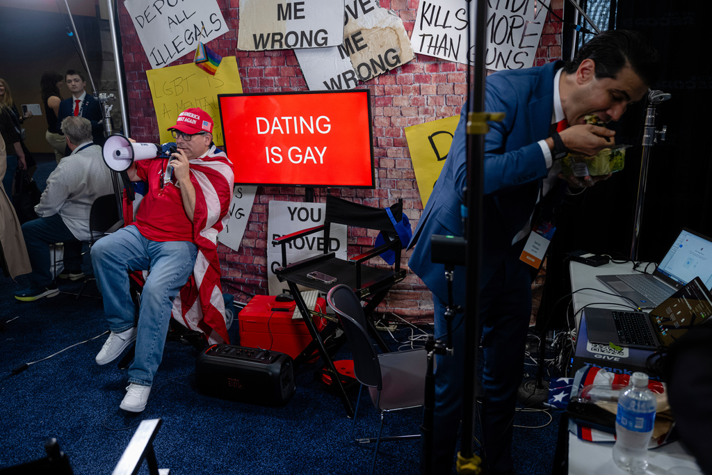 A right-wing podcaster speaks with attendees during Turning Point USA's AmericaFest 2025, Thursday, Dec. 18, 2025, in Phoenix. (AP Photo/Jon Cherry)