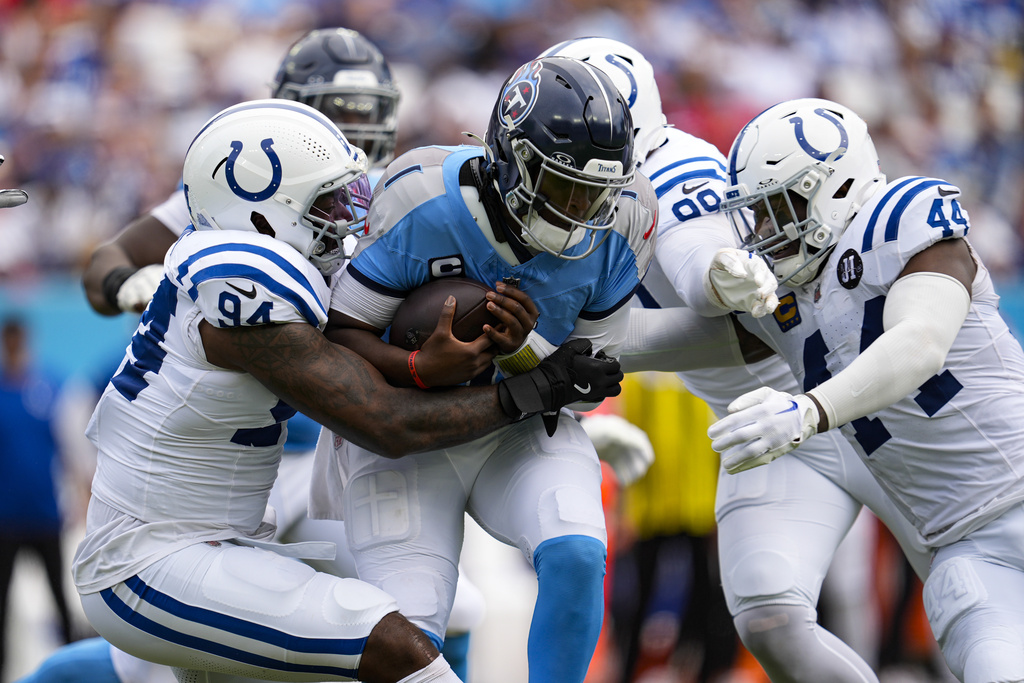 Tennessee Titans quarterback Cam Ward (1) is sacked by Indianapolis Colts defensive end Tyquan Lewis (94), defensive tackle Grover Stewart (90) and outside linebacker Zaire Franklin (44) during the first half of an NFL football game Sunday, Sept. 21, 2025, in Nashville, Tenn. (AP Photo/George Walker IV)