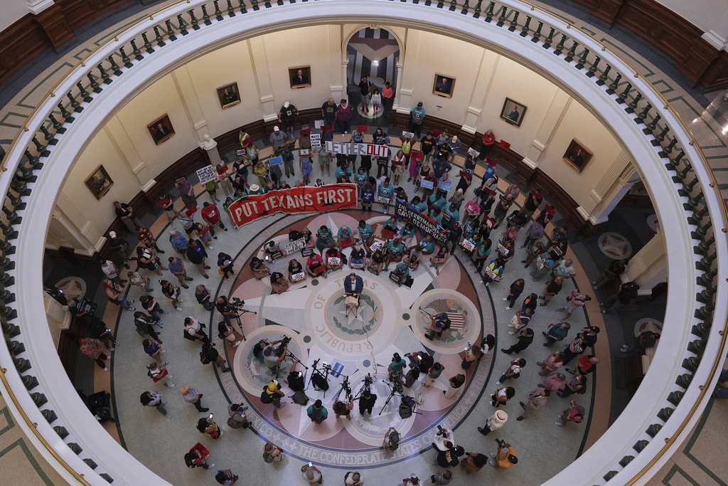 Protesters gather in the rotunda outside the House Chamber at the Texas Capitol as lawmakers debate a redrawn U.S. congressional map in Texas during a special session, Wednesday, Aug. 20, 2025, in Austin, Texas. (AP Photo/Eric Gay)
