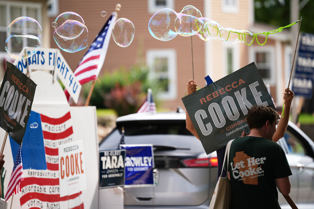 Supporters of Rebecca Cooke, Democratic candidate for Wisconsin's 3rd Congressional District, march in a Labor Day parade, Monday, Sept. 7, 2026, in Readstown, Wis. (AP Photo/Ellen Schmidt)