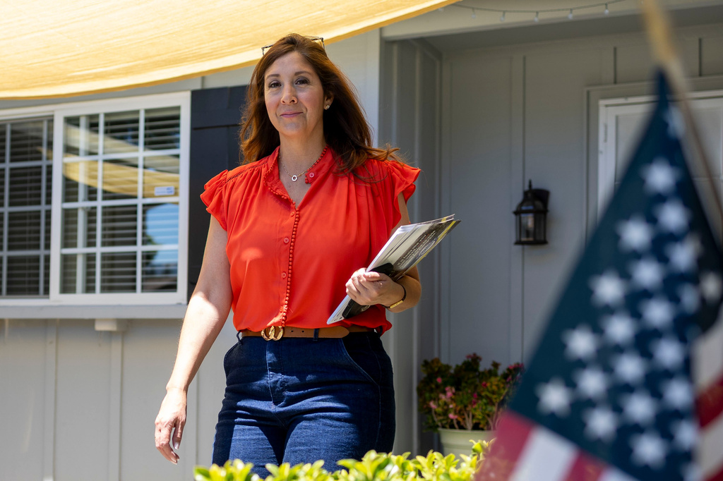 Melissa Hernandez, a Democratic candidate for Congress in California's 14th district, knocks on doors on Sunday, June 14, 2026, in Pleasanton, Calif. (AP Photo/Annie Barker )