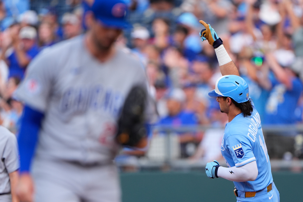 Kansas City Royals' Jac Caglianone, right, celebrates as he runs the bases past Chicago Cubs starting pitcher Clay Holmes, left, after hitting a solo home run during the first inning of a baseball game Saturday, Aug. 8, 2026, in Kansas City, Mo. (AP Photo/Charlie Riedel)