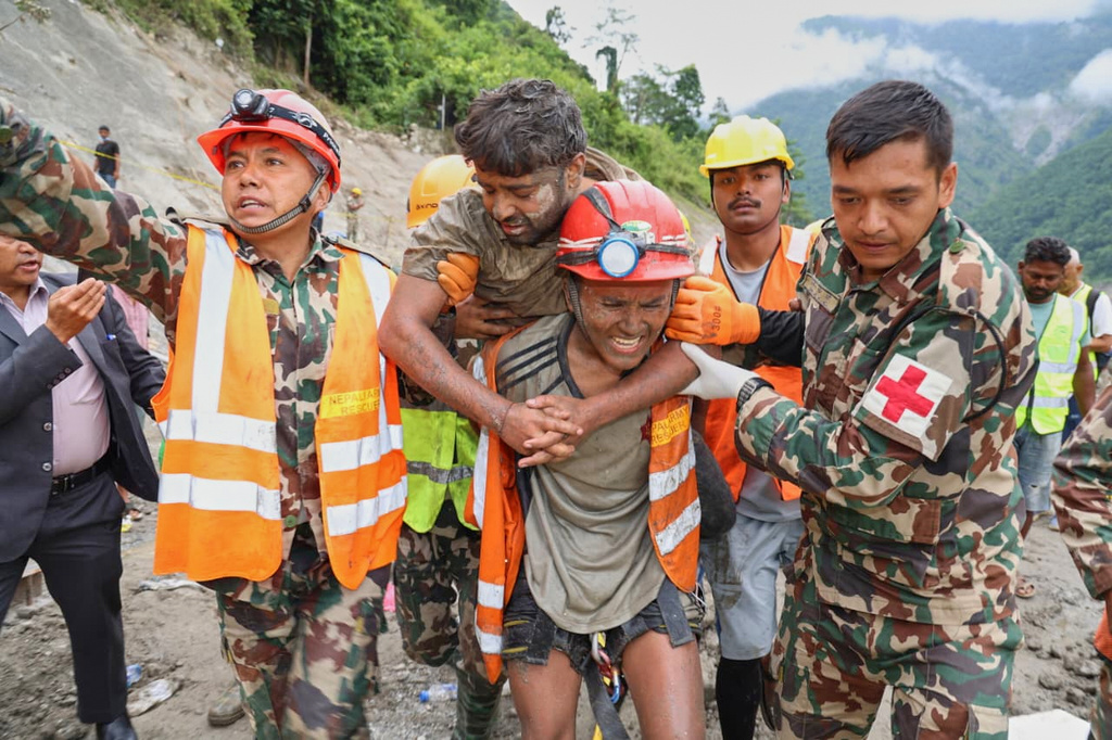 In this photo provided by the Nepal Army, soldiers rescue a worker alive from a tunnel during an ongoing operation at the Trishuli-3A hydropower project in Nepal's Rasuwa district, Friday, Sept. 4, 2026. (Nepal Army via AP)