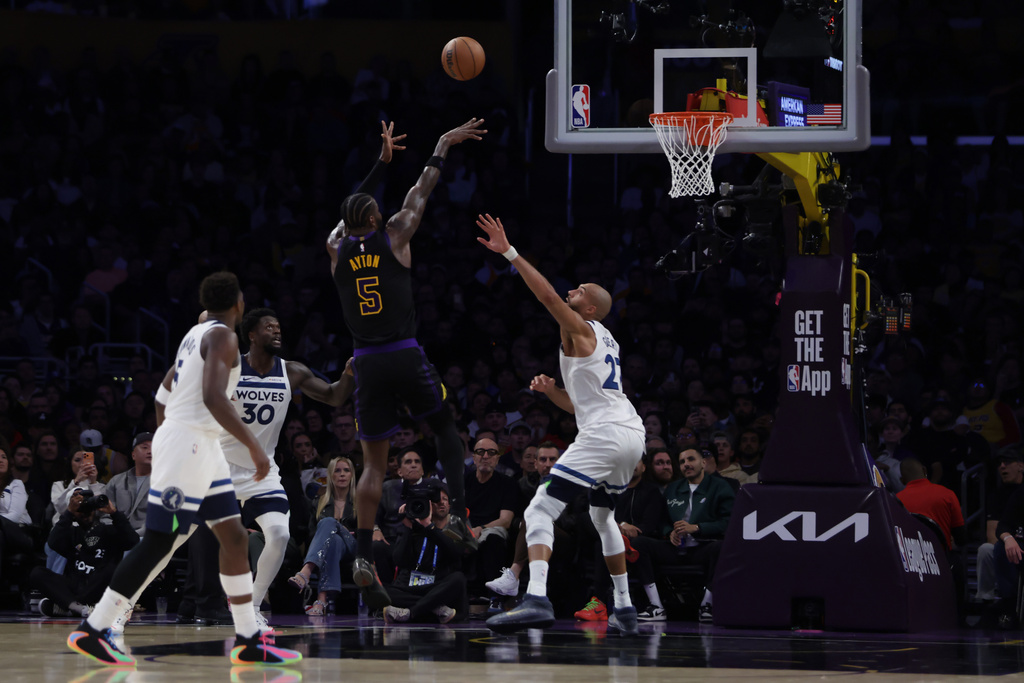 Los Angeles Lakers center Deandre Ayton (5) shoots against the Minnesota Timberwolves during the first half of an NBA basketball game, Tuesday, March 10, 2026, in Los Angeles. (AP Photo/Ethan Swope)