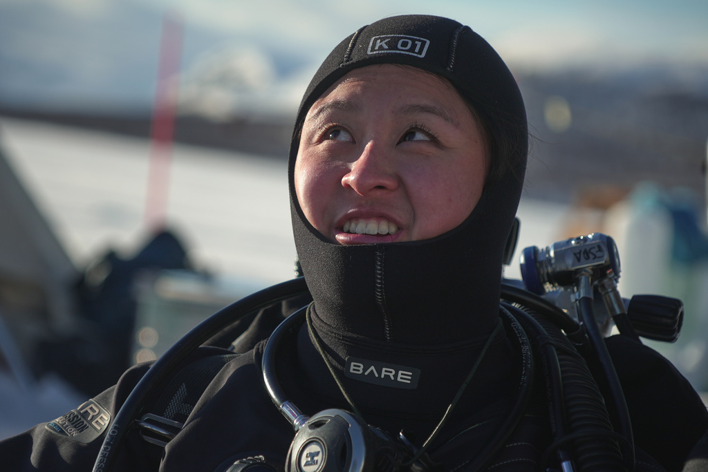 Caroline Chen, a scientific diver and research assistant, smiles before diving during a Polar Scientific Diving class in Kilpisjärvi, Finland, Finland, March 15, 2026. (AP Photo/Kostya Manenkov)