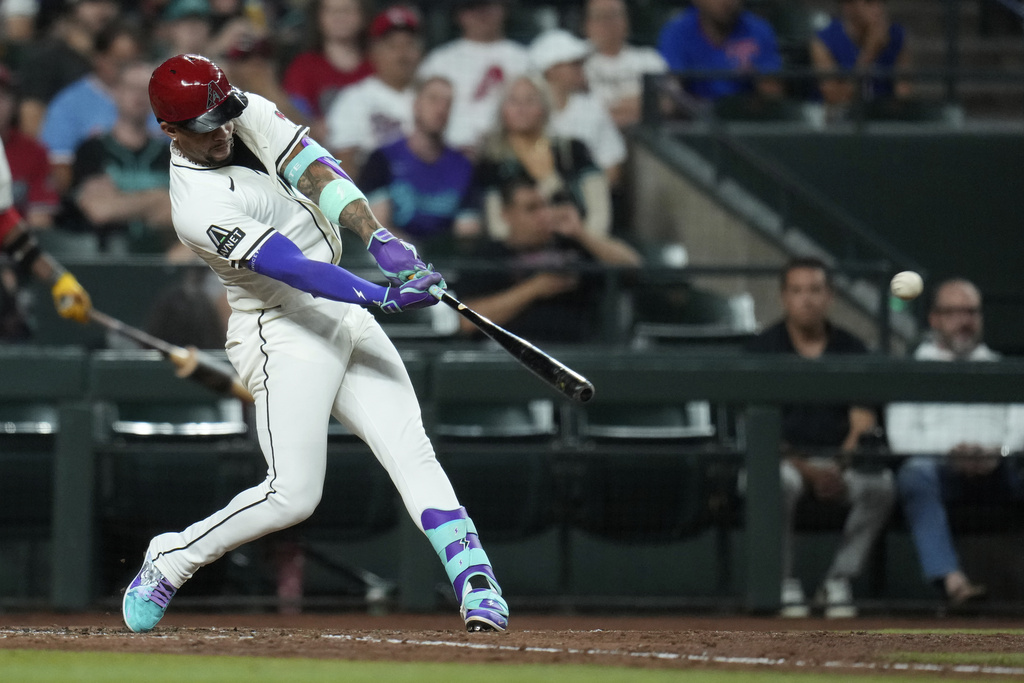Arizona Diamondbacks' Ketel Marte connects for a three-run home run against the Texas Rangers during the seventh inning of a baseball game Tuesday, Sept. 2, 2025, in Phoenix. (AP Photo/Ross D. Franklin)